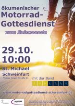 Ein Motorrad von hinten, das in die Weite fährt.